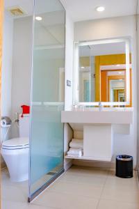 a bathroom with a shower and a sink and a toilet at Dragon Sea Hotel in Sầm Sơn