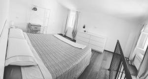 a bedroom with a large bed in a white room at Magici ricordi-Bordighera in Bordighera