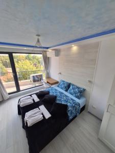 a bedroom with a bed and a couch at Cloud 6 -Top Center,360° view,Free private parking in Plovdiv