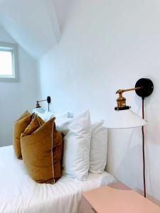 a bedroom with a bed with white pillows and a lamp at Cardiff luxury apartment in Cardiff
