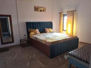 a bedroom with a large bed in a room at Private room in Retreat by Walias Farm Stay in Sohna +71 photos