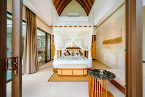 a bedroom with a bed with a canopy at Lalasa Villas Canggu in Canggu