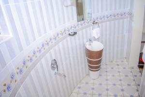 a bathroom with a toilet with a sink in it at OLOIRIEN HOTEL & RESORT in Narok