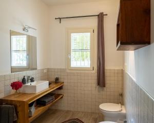 a bathroom with a sink and a toilet at Ocean Blue Apartment with Panoramic Pool ZanzibarHouses in Kiwengwa