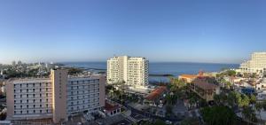 an aerial view of a city with buildings and the ocean at Lookout Point Tenerife Holiday Apartment Las Americas in Playa Fañabe