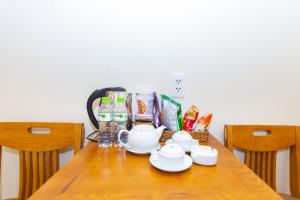 a wooden table with food and drinks on it at Dong Do Airport Hotel in Ho Chi Minh City