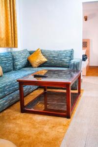 a living room with a blue couch and a coffee table at PLAYA HOTEL in Dakhla