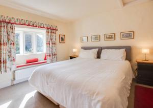 a bedroom with a large white bed and a window at Lyncroft in Aysgarth