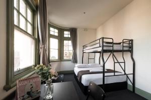 a bedroom with a bunk bed and a table at Sydney Central Inn in Sydney