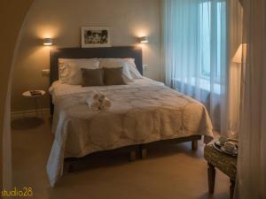 a bedroom with a bed with two towels on it at Studio28 Boutique Rooms in Pärnu