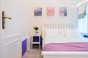 Un dormitorio con una cama y una mesa con un jarrón de flores en Revelton Suites Tallinn en Tallin