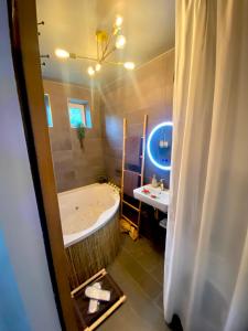 ein Badezimmer mit einer Badewanne und einem Waschbecken in der Unterkunft Exotic spa in Poissy