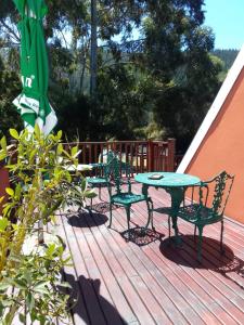a patio table and chairs on a deck at Tiffanys B&B, Pub & and Teagarden in Sedgefield