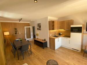 a kitchen and dining room with a table and a kitchen and a dining room at Wolf & Schaf Apartments in St. Wolfgang