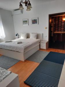 a bedroom with a bed and a blue rug at Pensiunea Corbeanca - cazare si evenimente in Corbeanca