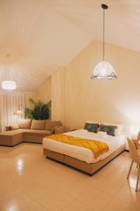 a bedroom with a large bed and a couch at 44 Forty Four Coast - Espinho in Espinho