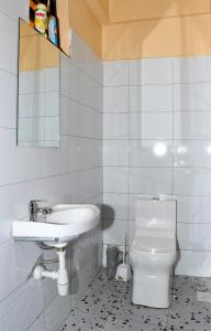 a bathroom with a sink and a toilet at Airport Bliss House in Kisumu
