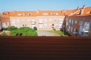 a view from a fence of a city with buildings at 44 Forty Four Coast - Espinho by Double Ninety Stays in Espinho