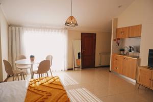 a kitchen and dining room with a table and a dining room at 44 Forty Four Coast - Espinho by Double Ninety Stays in Espinho
