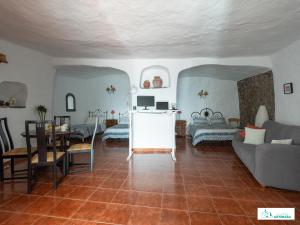 a living room with a couch and a table at Living Artenara - CAVE HOUSE & TERRACE Adults Only in Artenara