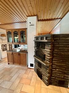 a kitchen with an oven in the middle of a room at Villa Grinberg in Mäntyharju