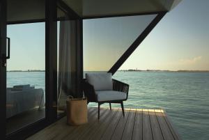 a chair sitting on the deck of a boat at AQVA The Exclusive Water Loft in Venice in Venice