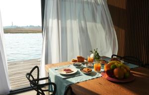 a table with food on it with a view of the water at AQVA The Exclusive Water Loft in Venice in Venice