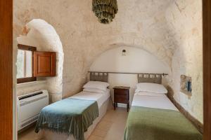 Giường trong phòng chung tại Trullo Due Ulivi