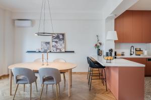 a kitchen and dining room with a wooden table and chairs at Bella in Athens