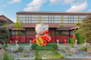 a house with a hello kitty statue in front of it at Tayama Farm Khaoyai in Nakhon Ratchasima