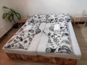 a bed with black and white pillows on it at Penzion U Hradeb in Znojmo
