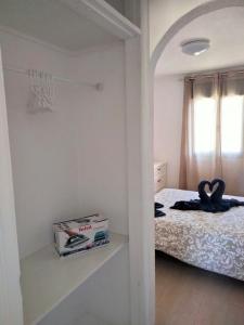 a white bedroom with a bed and a window at Mirador de Sotavento apartment 8241 in Costa Calma +6 photos