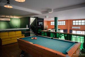 a pool table in a living room with a billiard at Navagio Villa 