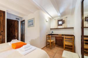 a bedroom with a bed and a desk in a room at Villa Marilina in Sant Miquel de Balansat +44 photos