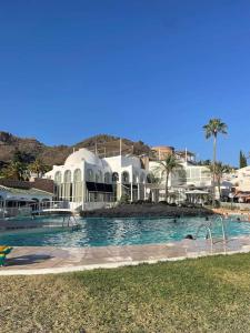 a large swimming pool in front of a resort at Lovely studio Nerja ground floor in Nerja