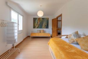 a bedroom with two beds and a window at El rincón de Matilde con jardín By Kabia Gestión in Barrika