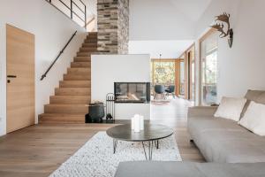 a living room with a couch and a table at Villa Seeblick in Altaussee