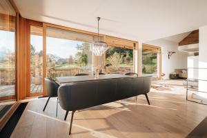 a dining room with a table and a large window at Villa Seeblick - Your Austrian Home in Altaussee