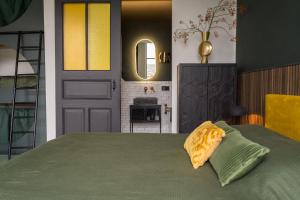 a bedroom with a bed and a door and a fireplace at De Kerck - bijzonder overnachten in Middelburg
