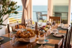 a wooden table with a plate of bread on it at Whalesong Lodge in Gansbaai