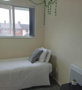 a white bedroom with a bed and a window at Fresher Space Home Stay in Walsall