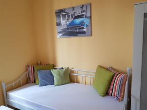 a bedroom with a bed with an old car on the wall at Nauwieser Apartments in Saarbrücken