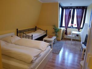 a bedroom with two beds and a tv in a room at Nauwieser Apartments in Saarbrücken