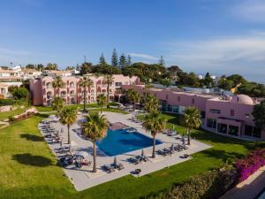 an aerial view of a resort with a pool and palm trees at Vila Gale Collection Praia in Albufeira