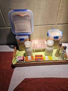 a tray with containers of food on a table at Di's B&B in Matamata +7 photos