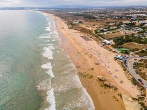 an aerial view of a beach with people on it at Vila Gale Collection Praia in Albufeira