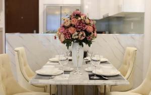 a table with a vase with a bouquet of flowers at 30% promotion for Gold view apartment in the center of District 4, Ho Chi Minh, Vietnam in Ho Chi Minh City