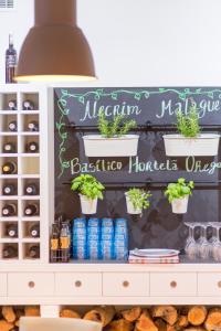 a shelf with potted plants and cans of soda at Vila Gale Collection Praia in Albufeira
