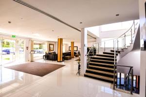 a living room with a staircase in a house at Vila Gale Collection Praia in Albufeira