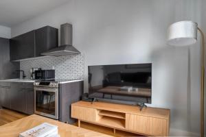 a kitchen with a large tv and a table at East Village 1br w doorman wd nr Union Square NYC-1153 in New York